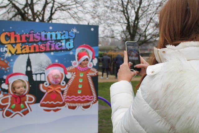 Taking snaps was a popular pastime at the festival. This mum couldn't resist getting her mobile out to photograph youngsters putting their heads through the holes of a 'Christmas In Mansfield' display.