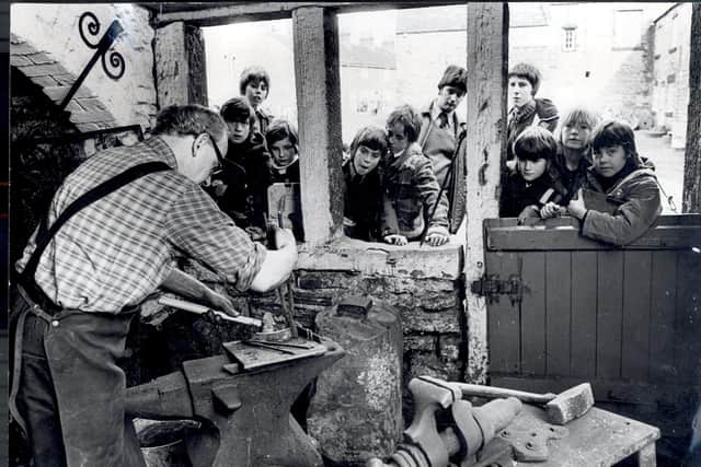 March 1978 and Abbeydale Industrial Hamlet is as popular as ever as youngsters watch a craftsman at work during one of the working days