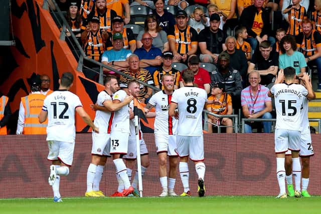 Sheffield United's Oliver McBurnie (centre) celebrates with his team-mates after scoring their side's first goal of the game during the Sky Bet Championship match at the MKM Stadium, Hull. Picture date: Sunday September 4, 2022. PA Photo. See PA story SOCCER Hull. Photo credit should read: Nigel French/PA Wire.