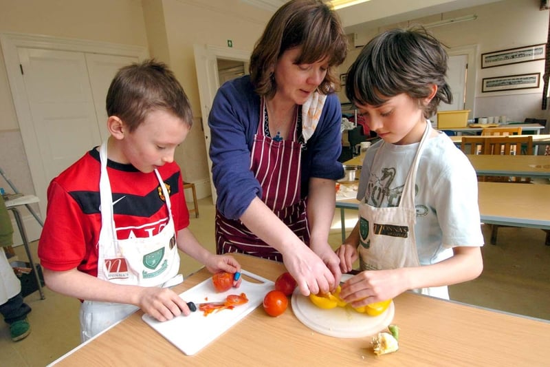 Food technology teacher Deb Loasby  helps Travis Caddy, left, and Joe Barber at Westbourne Junior School, Sheffield in March 2010