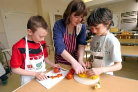 Food technology teacher Deb Loasby  helps Travis Caddy, left, and Joe Barber at Westbourne Junior School, Sheffield in March 2010