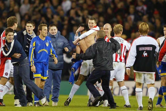 Jubilant United fans invade the pitch after the Worthington Cup third round tie with Leeds at the Lane in November 2002.