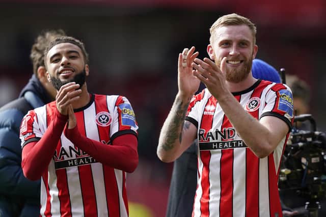 Jayden Bogle and Oliver McBurnie clap Sheffield United's supporters: Andrew Yates / Sportimage