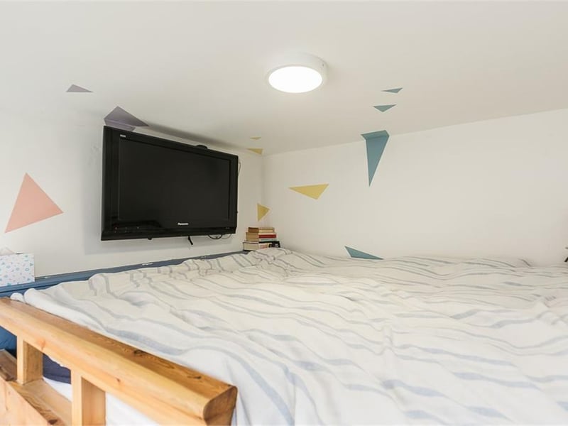 Mezzanine level bed in bedroom 3.