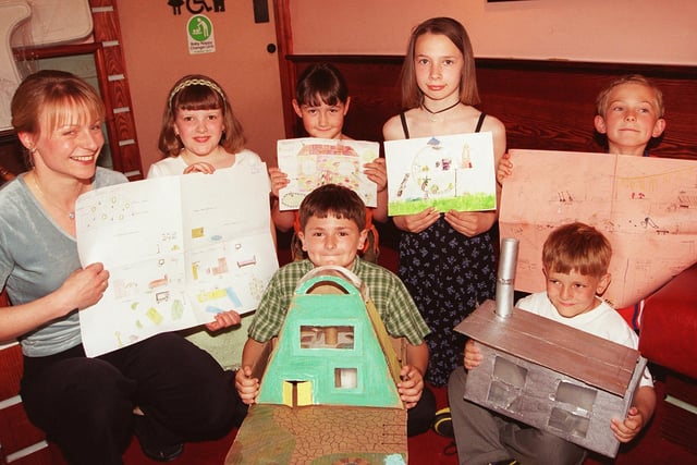Pictured at the Deep Pan Pizza Restaurant, Crystal Peaks, in 1999 where winners in  the Design a Dream House competition  receiving their awards and a meal at the restaurant. The competition was run by Civil Engineering company Anthony Hunt Associates. Seen is Catherine Hodson. who presented the prizes. with the winners