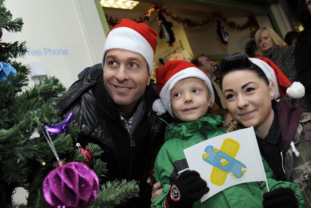 Michael Vaughan and Lucy Spraggan help young patient Charlie Briggs switch on the Christmas lights at Sheffield Children's Hospital in 2016
