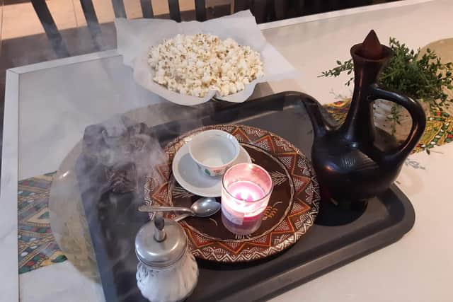 Sara toasts Ethiopian coffee beans before making coffee served alongside burning incense. It is as good as any in Sheffield.