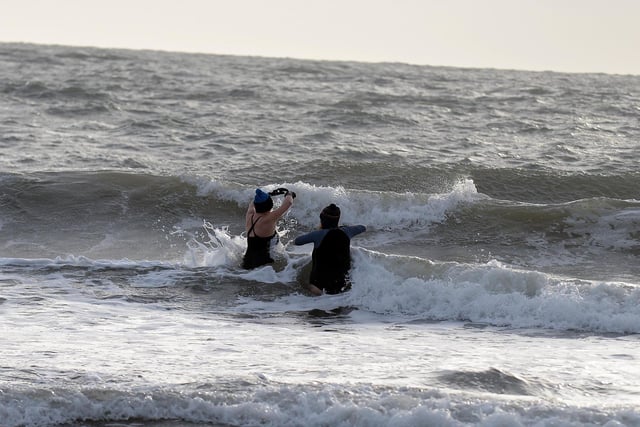 Brave swimmers test the North Sea on the Morning of Storm Eunice at Sunderland seafront