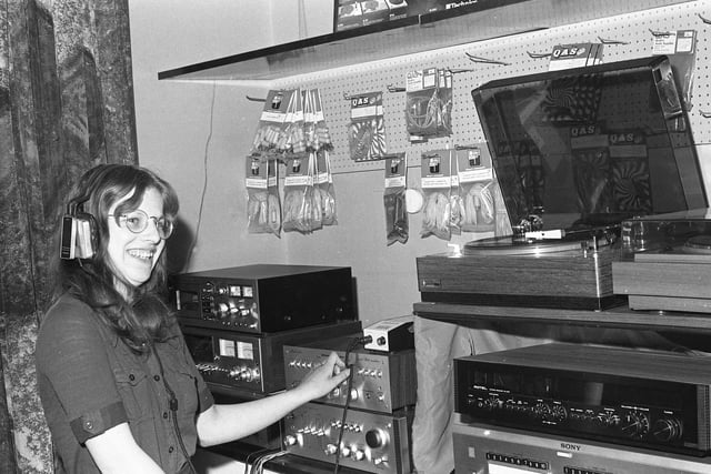 Anne Page listens in to some music from the hi fi equipment on show in the showroom at Saxons in 1975.