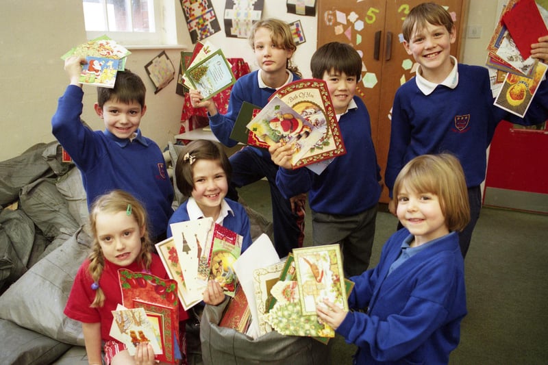 Pupils from John F Kennedy Primary School filled 20 sacks with used Christmas cards in this 1999 scene. Pictured are, left to right back: James Rae, Danielle Myers, Ken Mawhinney, and Liam Lowrie, front: Hannah Jobson, Caroline Grist and Megan Dee.