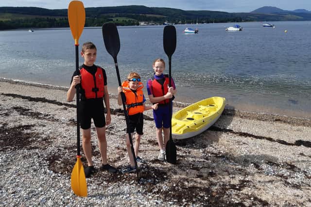 George, William and Annabel Hollingworth prepare to go kayaking