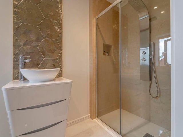 Another example of the impressive en suite facilities at The Pinnacle. A modern walk-in shower is at the heart of the room.