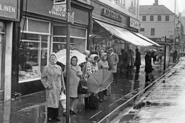 Do you recognise the shops in the background of this Fowler Street bus queue in 1976?
