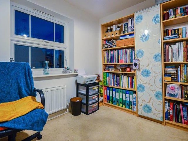A second view of the third bedroom shows there is plenty of space for storage. Maybe a place to keep your collection of books, CDs or DVDs.