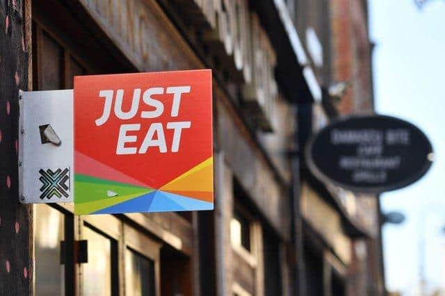 A sign for Just Eat, a food delivery service (Photo by BEN STANSALL / AFP) (Photo by BEN STANSALL/AFP via Getty Images)