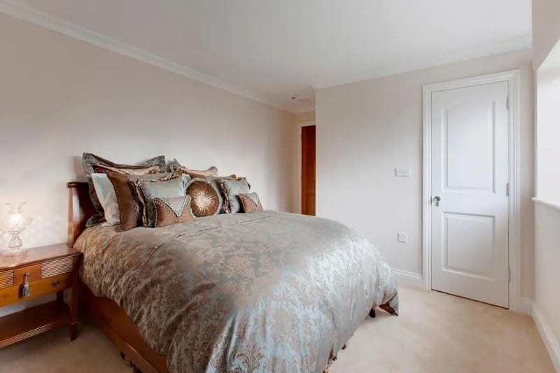 Spacious double bedroom with a front-facing, double-glazed window, pendant lighting and TV/aerial point.