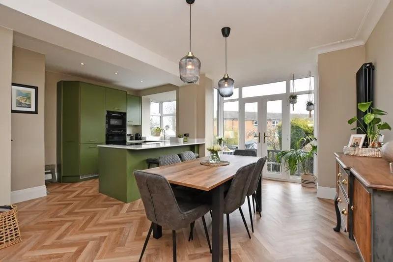 The dining area has a patterned laminate floor and large windows to the rear to allow in plenty of light.