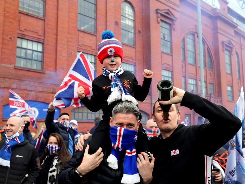 Rangers fans celebrate outside of the Ibrox Stadium after Rangers win the Scottish Premiership title.