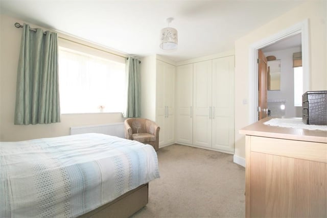 Built-in wardrobes and an ensuite shower room are features of the master bedroom.
