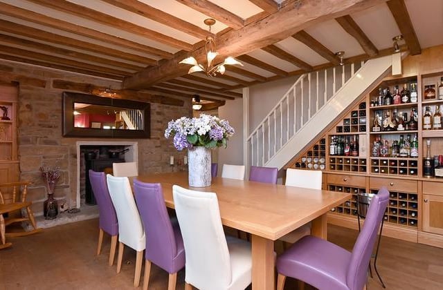 The dining room has a feature fireplace and an impressive fitted drinks area.