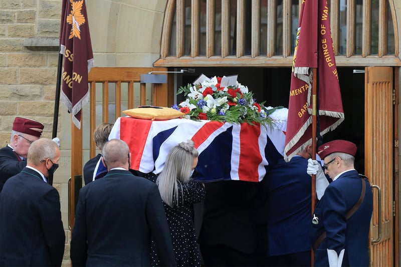 Douglas Parker's Union flag-draped coffin passes the honour guard on its way into the church