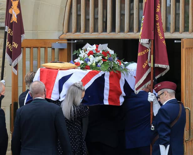 Douglas Parker's Union flag-draped coffin passes the honour guard on its way into the church