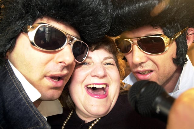 Nonna's restaurant proprietors Maurizio Mori and Gian Bohan, right get the Elvis feeling with McMillan cancer relief appeal manager Tracy Viner for the " Shake It" charity night in 2002