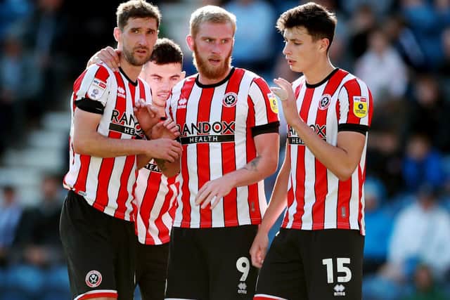 Chris Basham (left) and Oli McBurnie (centre) are among the few first team players remaining at Sheffield United during the break: Simon Bellis / Sportimage