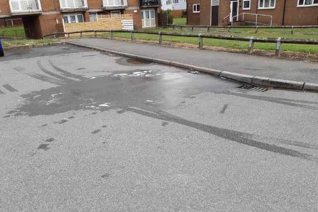 This was the scene at Bowshaw Close, Batemoor, today, as work to bring the street back to normal went ahead after a police murder investigation. Water and detergent can been seen where workmen have today scrubbed the street clean