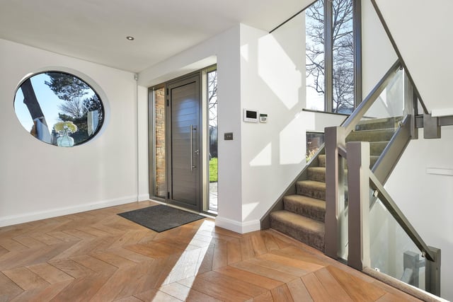 Entering the house you are greeted by a spacious entrance hall with glass balustrade staircase and three storey height feature window.