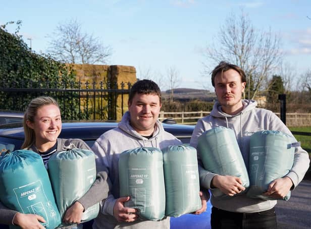 Ellie Dawson, Ben Marshall (centre) and Jason Moore with some of the sleeping bags and thermal blankets already donated ready to be taken to Poland