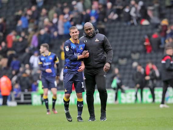 Darren Moore and Matty Blair leave the pitch after the win over MK Dons.