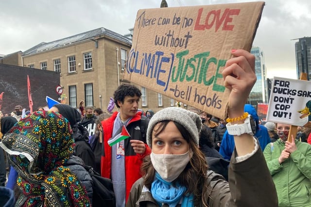 An activist carrying a sign which reads: "There can be no love without climate justice."