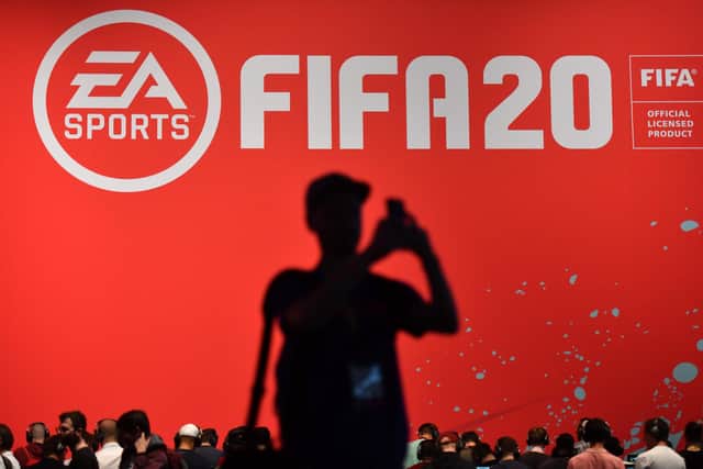 Visitors play the "FIFA 20" football game at the Gamescom video games trade fair in Cologne, western Germany: NA FASSBENDER/AFP via Getty Images