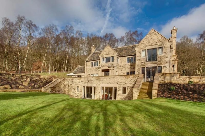 To the front of the property is an extensive sandstone seating terrace with exterior lighting and steps leading down to a generously sized formal garden, which is mainly laid-to lawn with flower/shrub borders.