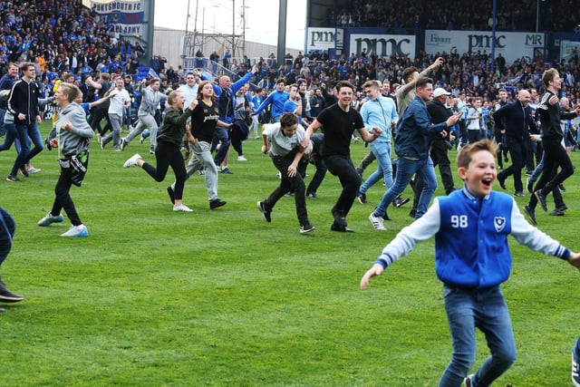 Fans invade the pitch after the final whistle.