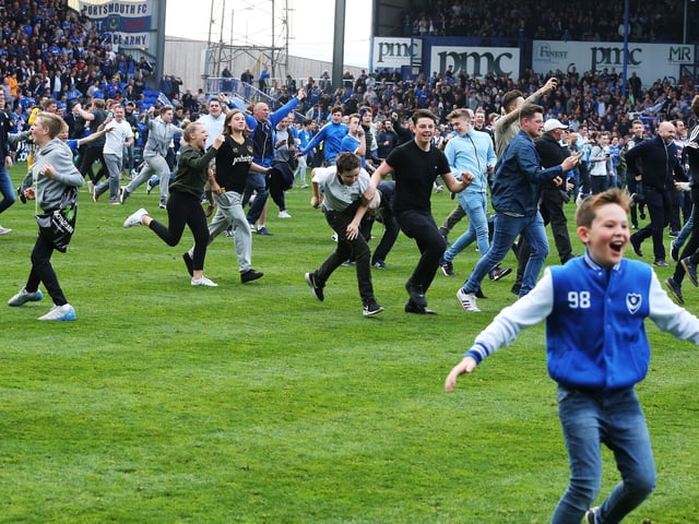 Fans invade the pitch after the final whistle.
