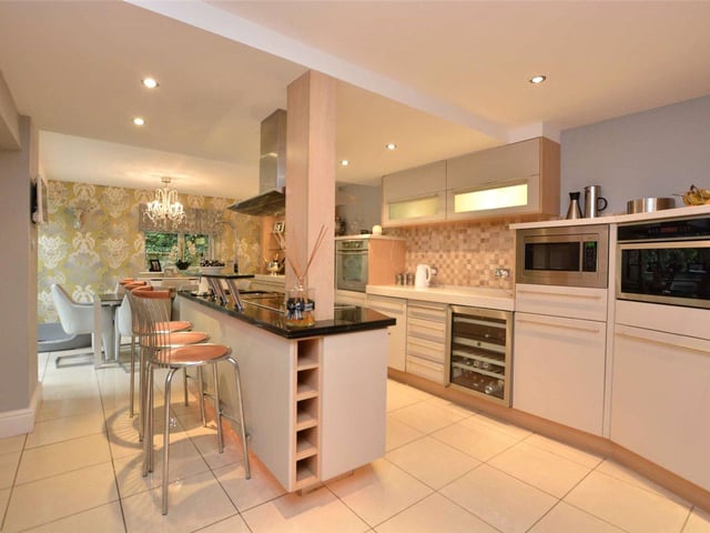 The open plan modern dining kitchen serves as the hub or the house and benefits from fitted units and appliances, with a central island and breakfast bar.