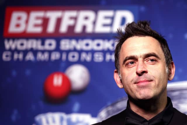 Snooker fans can get their photo taken with the World Championship trophy at the new Ronnie O'Sullivan pop-up store at Meadowhall (pic: George Wood/PA Wire)
