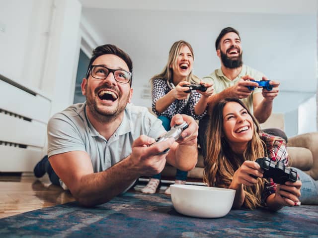 A group of friends playing video games together at home