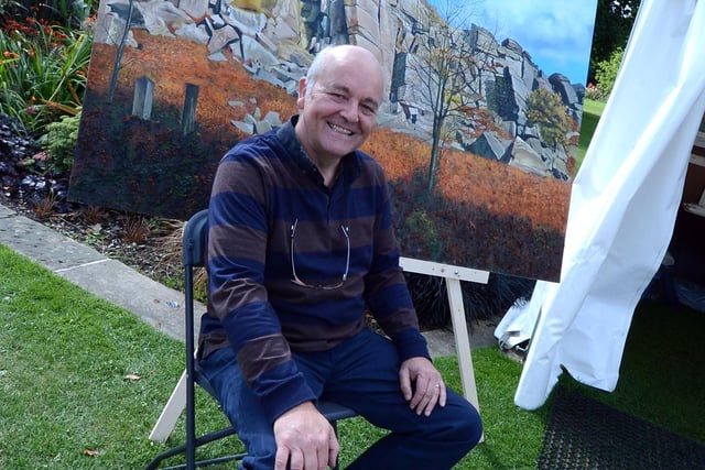 Art in the Gardens took place at the Botanical Gardens in Sheffield  in 2013. Our picture shows Outibridge artist Graham Clark, with his painting of Stanage Edge.