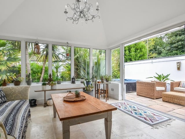 The bi-folding doors in the garden room lead to an outside seating area