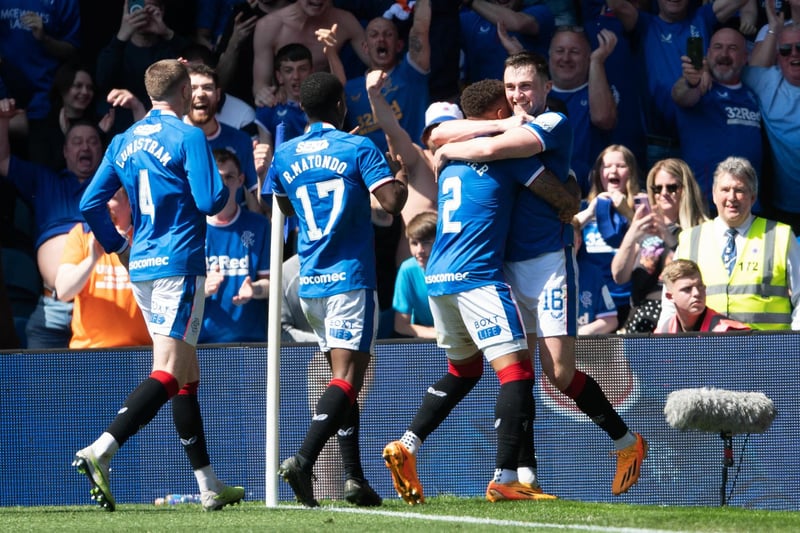 The former Hearts defender is mobbed by his Rangers team-mates after scoring the second goal of the game.