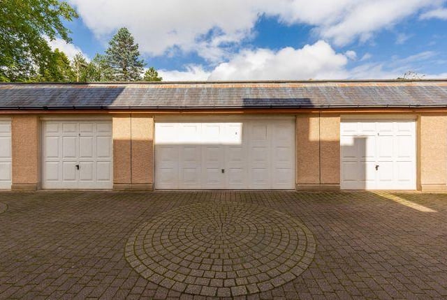 Outside, there is a double garage, alongside off street parking.