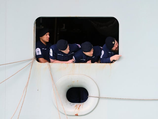 Sailors on HMS Queen Elizabeth as she returns to Portsmouth. Picture: (020720-5208)