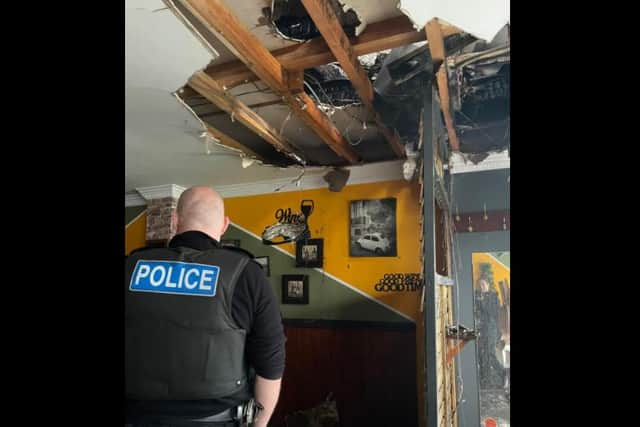 Police inspect the damage after the cilaing fell through at Ferdinando's on Meadowhead