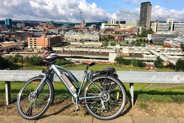 An electric bike with Sheffield skyline in the background.