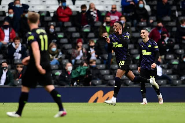 Joe Willock of Newcastle United celebrates after scoring the opening goal during the Premier League match between Fulham and Newcastle United at Craven Cottage on May 23, 2021 in London, England.