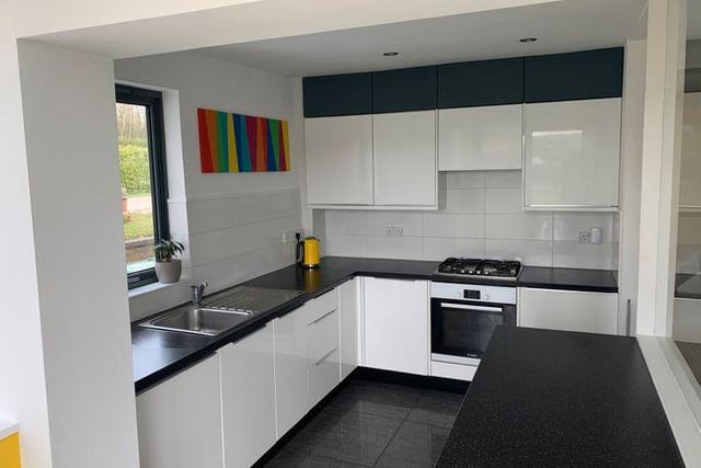 The modern fitted kitchen has a built-in fridge and separate freezer and integrated dishwasher.