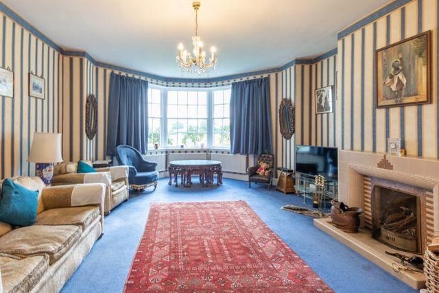 If there is one room that sums up how characterful the East Stoke property is, it's this lovely, long lounge. It includes a feature fireplace and a bay window.